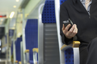 Man in train with phone in hand